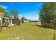 A spacious backyard with a brick patio and a green lawn at 11245 Sw 63Rd Terrace Rd, Ocala, FL 34476