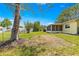 Expansive backyard view featuring a screened in patio, mature trees, and meticulously kept lawn with plenty of space at 11245 Sw 63Rd Terrace Rd, Ocala, FL 34476