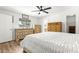 Bright bedroom featuring light wood floors and a ceiling fan, with a beautiful view from the window at 11245 Sw 63Rd Terrace Rd, Ocala, FL 34476