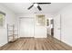 A bedroom with wood-look flooring, a closet, and a ceiling fan at 11245 Sw 63Rd Terrace Rd, Ocala, FL 34476