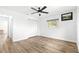 Bedroom with wood-look flooring, ceiling fan, and white closet doors at 11245 Sw 63Rd Terrace Rd, Ocala, FL 34476