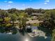 Aerial view of the clubhouse featuring gazebo on the pond, ample parking and mature trees at 11245 Sw 63Rd Terrace Rd, Ocala, FL 34476