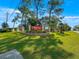 Inviting entrance to Spruce Creek 55+ community with lush landscaping, fencing and signage at 11245 Sw 63Rd Terrace Rd, Ocala, FL 34476