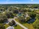 Aerial view of community featuring a pool, clubhouse, pond, green spaces, mature trees, and neighborhood streets at 11245 Sw 63Rd Terrace Rd, Ocala, FL 34476
