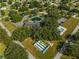 Beautiful aerial showcasing the community amenities; pool, clubhouse, shuffleboard, pond, parking, and green spaces at 11245 Sw 63Rd Terrace Rd, Ocala, FL 34476