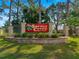 Welcoming entrance to Spruce Creek 55+ Community with lush landscaping and a decorative brick sign at 11245 Sw 63Rd Terrace Rd, Ocala, FL 34476