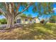 Charming single-story home with manicured lawn, mature trees, screened in lanai, and well maintained landscape at 11245 Sw 63Rd Terrace Rd, Ocala, FL 34476