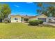 Inviting yellow home with a neat lawn, complemented by mature landscaping and a pristine walkway at 11245 Sw 63Rd Terrace Rd, Ocala, FL 34476