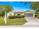 Charming single-story home featuring a well-manicured lawn and an attached two-car garage at 11245 Sw 63Rd Terrace Rd, Ocala, FL 34476