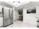 Bright kitchen featuring stainless steel appliances, white marble floors, and a view into a separate dining area at 11245 Sw 63Rd Terrace Rd, Ocala, FL 34476
