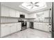 Modern kitchen with white cabinetry, stainless steel appliances, granite countertops, and tile backsplash at 11245 Sw 63Rd Terrace Rd, Ocala, FL 34476