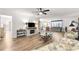 Open-concept living room featuring light wood floors, a ceiling fan, and comfortable seating at 11245 Sw 63Rd Terrace Rd, Ocala, FL 34476