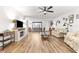 Spacious living room with wood-look floors, neutral walls, and a decorative fireplace at 11245 Sw 63Rd Terrace Rd, Ocala, FL 34476