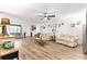 Bright living room boasts wood floors, ceiling fan, and ample space for entertaining at 11245 Sw 63Rd Terrace Rd, Ocala, FL 34476