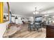 Spacious living room with light wood floors, plush seating and decorative mirror accents for a bright and airy feel at 11245 Sw 63Rd Terrace Rd, Ocala, FL 34476