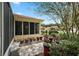 Beautifully landscaped backyard featuring lush greenery, a small patio, and privacy at 13786 Se 88Th Ct, Summerfield, FL 34491