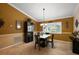 Inviting dining room featuring tiled floors, wainscoting, a decorative light fixture, and plantation shutters at 13786 Se 88Th Ct, Summerfield, FL 34491