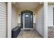 Inviting front entrance with decorative sidelights, a covered porch with columns, and a tiled entryway at 13786 Se 88Th Ct, Summerfield, FL 34491