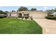 Charming single-story home featuring a well-manicured lawn, decorative stone driveway, and attached two-car garage at 13786 Se 88Th Ct, Summerfield, FL 34491