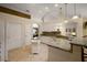 Bright kitchen with granite countertops, white cabinetry, and a center island open to the breakfast nook at 13786 Se 88Th Ct, Summerfield, FL 34491