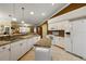 Well-appointed kitchen features white appliances, granite countertops, and a functional center island at 13786 Se 88Th Ct, Summerfield, FL 34491