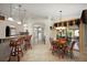 Open-concept kitchen and breakfast nook area featuring granite counters, white cabinets, and bar seating at 13786 Se 88Th Ct, Summerfield, FL 34491
