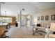 Bright and airy living room featuring tile flooring, large windows, and an open floor plan to the dining area at 13786 Se 88Th Ct, Summerfield, FL 34491