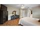 Bright main bedroom features a ceiling fan, hardwood floors and neutral paint at 13786 Se 88Th Ct, Summerfield, FL 34491