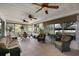 Bright sunroom featuring tile floors, multiple ceiling fans, and comfortable seating, perfect for relaxation and enjoyment at 13786 Se 88Th Ct, Summerfield, FL 34491