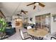 Relaxing sunroom with tiled floors, ceiling fans, and access to the kitchen, perfect for entertaining guests at 13786 Se 88Th Ct, Summerfield, FL 34491