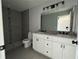 Bathroom featuring a walk-in shower, dual vanity and modern fixtures at 15419 Sw 65Th Terrace Rd, Ocala, FL 34473