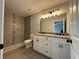 Elegant bathroom featuring granite vanity, tiled shower, and modern lighting at 15419 Sw 65Th Terrace Rd, Ocala, FL 34473