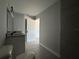 Bathroom featuring a single vanity, shower and gray flooring at 15419 Sw 65Th Terrace Rd, Ocala, FL 34473