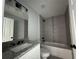 Modern bathroom featuring granite vanity, shower, and bathtub at 15419 Sw 65Th Terrace Rd, Ocala, FL 34473