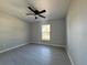Cozy bedroom featuring gray walls, tile floor, and a ceiling fan at 15419 Sw 65Th Terrace Rd, Ocala, FL 34473