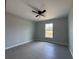 Bright bedroom featuring modern design, a fan and sleek gray flooring at 15419 Sw 65Th Terrace Rd, Ocala, FL 34473