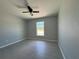 Bedroom featuring a window, ceiling fan and gray tile flooring at 15419 Sw 65Th Terrace Rd, Ocala, FL 34473