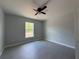 Bright bedroom featuring modern design, a fan and sleek gray flooring at 15419 Sw 65Th Terrace Rd, Ocala, FL 34473