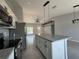 Modern kitchen with stainless steel appliances, white cabinets, granite countertops, and a large kitchen island at 15419 Sw 65Th Terrace Rd, Ocala, FL 34473