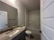 Bathroom showcasing a granite vanity, and bathtub-shower combo with bright neutral walls at 15833 Se 97Th Ter, Summerfield, FL 34491