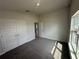 Bright bedroom featuring neutral walls, vaulted ceilings, carpet, a closet and a view to the hall at 15833 Se 97Th Ter, Summerfield, FL 34491