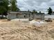 Construction site shows block walls being built for a new house on a sandy lot under a cloudy sky at 15833 Se 97Th Ter, Summerfield, FL 34491