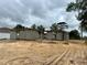 Ongoing house construction showing concrete blocks with a cloudy sky backdrop on a sandy lot at 15833 Se 97Th Ter, Summerfield, FL 34491