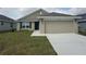 Charming single-story home with a two-car garage, well-maintained lawn, and inviting front entrance at 15833 Se 97Th Ter, Summerfield, FL 34491