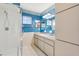 Well-lit bathroom with large mirror, walk-in shower and blue accents at 17915 Se 102Nd Ter, Summerfield, FL 34491