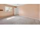 Carpeted bedroom features neutral walls, and a view to the backyard at 17915 Se 102Nd Ter, Summerfield, FL 34491