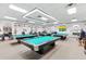 Well-lit billiards room with multiple pool tables, offering a fun recreational space at 17915 Se 102Nd Ter, Summerfield, FL 34491
