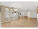 Open-concept living and dining room with hardwood floors, lots of natural light, and modern fixtures at 17915 Se 102Nd Ter, Summerfield, FL 34491