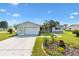 Well-maintained home features a clean driveway, attached garage, and landscaped garden beds on a sunny day at 17915 Se 102Nd Ter, Summerfield, FL 34491