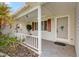 Inviting front porch with a decorative door, charming details, and cozy ambiance at 17915 Se 102Nd Ter, Summerfield, FL 34491